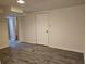 Spacious basement featuring modern gray wood floors and a white door at 1917 Penelope Nw Rd, Atlanta, GA 30314