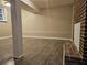 Open basement featuring a brick fireplace, wood floors, and a window at 1917 Penelope Nw Rd, Atlanta, GA 30314