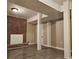 Spacious basement with brick accent wall, wood floors, and support beams at 1917 Penelope Nw Rd, Atlanta, GA 30314