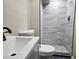 Bathroom featuring a toilet, vanity and tiled walk in shower with glass doors at 1917 Penelope Nw Rd, Atlanta, GA 30314