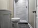 Bathroom featuring a toilet, cabinet and a tile shower with glass doors at 1917 Penelope Nw Rd, Atlanta, GA 30314