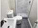 Bathroom featuring a toilet, vanity and a tiled walk in shower with glass doors at 1917 Penelope Nw Rd, Atlanta, GA 30314