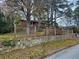 Red brick home with a retaining wall and fencing at 1917 Penelope Nw Rd, Atlanta, GA 30314