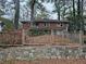 Charming brick home featuring mature trees and a stone retaining wall at 1917 Penelope Nw Rd, Atlanta, GA 30314