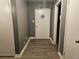 Hallway with grey walls, grey flooring, and white doors at 1917 Penelope Nw Rd, Atlanta, GA 30314