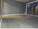 Living room with grey walls, grey flooring, and sliding glass doors at 1917 Penelope Nw Rd, Atlanta, GA 30314
