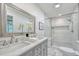 Modern bathroom featuring double vanity, marble countertop, and walk-in shower at 2011 Lexington Ave, Atlanta, GA 30344