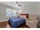 Cozy bedroom with a ceiling fan, hardwood floors, and bright natural light from the window at 2011 Lexington Ave, Atlanta, GA 30344