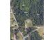Aerial view of wooded acreage including house and frontage on Plunkett and Rockland Roads at 6900 Rockland Rd, Stonecrest, GA 30038