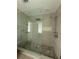 Elegant bathroom features a frameless walk-in shower with a rainfall shower head at 6900 Rockland Rd, Stonecrest, GA 30038
