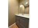 Stylish powder room featuring a modern vanity, quartz countertop, and sleek mirror at 6900 Rockland Rd, Stonecrest, GA 30038