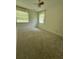 Bright bedroom featuring neutral carpet, ceiling fan, and natural light from windows at 6900 Rockland Rd, Stonecrest, GA 30038