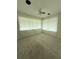 Comfortable bedroom with plush carpeting and abundant natural light through large windows at 6900 Rockland Rd, Stonecrest, GA 30038