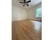 Sun-filled bedroom features hardwood floors, fan and lots of natural light at 6900 Rockland Rd, Stonecrest, GA 30038