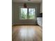 Cozy dining area with hardwood floors, a view to the back, and modern cabinets at 6900 Rockland Rd, Stonecrest, GA 30038