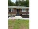 Newly landscaped front entrance welcomes guests with a charming stone walkway at 6900 Rockland Rd, Stonecrest, GA 30038