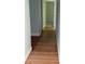 Hallway with hardwood flooring and neutral paint, leading to bedrooms at 6900 Rockland Rd, Stonecrest, GA 30038