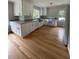 Beautiful kitchen with bright white cabinets, stainless appliances, and hardwood floors at 6900 Rockland Rd, Stonecrest, GA 30038