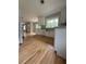 Well-lit kitchen with stainless steel appliances, modern cabinets, and hardwood floors at 6900 Rockland Rd, Stonecrest, GA 30038