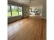 Open living space with hardwood floors, a large window, and open concept kitchen at 6900 Rockland Rd, Stonecrest, GA 30038