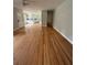 Open-concept living room with hardwood floors, flowing into kitchen at 6900 Rockland Rd, Stonecrest, GA 30038