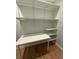 Small office features built-in shelving, desk, and hardwood floors at 6900 Rockland Rd, Stonecrest, GA 30038