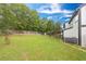 Spacious backyard with well-manicured lawn and a covered patio at 8320 Mayfern Dr, Fairburn, GA 30213
