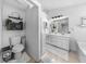 Bright bathroom with dual vanity sinks, white cabinetry, and a separate toilet room at 8320 Mayfern Dr, Fairburn, GA 30213