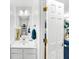 Clean and bright bathroom featuring a white vanity and mirror in a well-lit area at 8320 Mayfern Dr, Fairburn, GA 30213