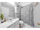Well-lit bathroom featuring a bright mirror, and a white sink and toilet with a grey patterned shower curtain at 8320 Mayfern Dr, Fairburn, GA 30213
