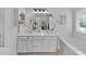 Clean bathroom with dual sinks, ample counter space, and a separate tub at 8320 Mayfern Dr, Fairburn, GA 30213