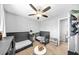 Neutral bedroom featuring two neutral cribs, a ceiling fan, and a bright double window at 8320 Mayfern Dr, Fairburn, GA 30213