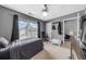 Comfortable bedroom with carpet, a ceiling fan, and a bright window for lots of natural light at 8320 Mayfern Dr, Fairburn, GA 30213