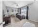 Cozy bedroom featuring neutral walls, plush carpet, and a bright window for ample natural light at 8320 Mayfern Dr, Fairburn, GA 30213