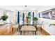 Dining room with a glass table, six chairs, hardwood floors, and bright natural light at 8320 Mayfern Dr, Fairburn, GA 30213