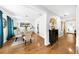 Elegant dining room with hardwood floors, wainscoting, and a glass top table at 8320 Mayfern Dr, Fairburn, GA 30213