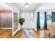 Bright foyer with hardwood floors and a view of the living spaces at 8320 Mayfern Dr, Fairburn, GA 30213