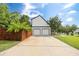 Two-car garage with a long driveway and a partial view of the home at 8320 Mayfern Dr, Fairburn, GA 30213