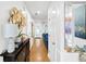 Hallway with wood floors, modern decor, and a glimpse of the living room at 8320 Mayfern Dr, Fairburn, GA 30213