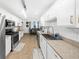 Charming kitchen featuring white cabinets, stainless steel appliances and lots of counter space at 8320 Mayfern Dr, Fairburn, GA 30213