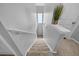 Carpeted staircase with white banister leading to the upper level at 8320 Mayfern Dr, Fairburn, GA 30213