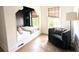 Charming bedroom nook with built-in bed, plaid roman shades, hardwood floors, comfy chair and modern lamp at 10540 Serenbe Ln, Chattahoochee Hills, GA 30268