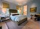 Charming bedroom featuring stylish decor and a glimpse into the ensuite bathroom at 10540 Serenbe Ln, Chattahoochee Hills, GA 30268