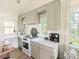 Bright kitchen featuring stainless appliances, stone counters, and natural light at 10540 Serenbe Ln, Chattahoochee Hills, GA 30268