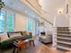 Inviting living room featuring a staircase and comfortable seating at 10540 Serenbe Ln, Chattahoochee Hills, GA 30268