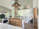 Modern kitchen with island overlooking living area featuring a stone fireplace at 10540 Serenbe Ln, Chattahoochee Hills, GA 30268