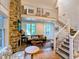 Spacious living room with stone fireplace and cozy seating on hardwood floors at 10540 Serenbe Ln, Chattahoochee Hills, GA 30268