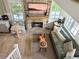Open living room with a stone fireplace and comfortable seating at 10540 Serenbe Ln, Chattahoochee Hills, GA 30268