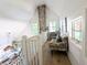 Loft area with a stone chimney and a cozy seating area at 10540 Serenbe Ln, Chattahoochee Hills, GA 30268