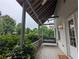 Inviting porch with swing, ceiling fan, and views of landscaped surroundings at 10540 Serenbe Ln, Chattahoochee Hills, GA 30268